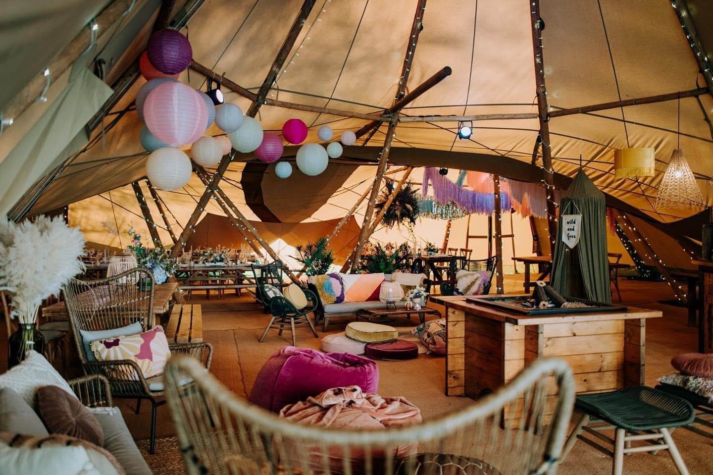 Setup inside a tent full of comfy seating